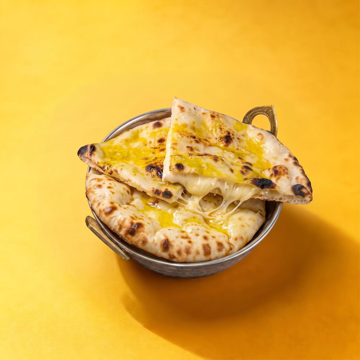 Cheese and garlic naan in a steel basket
