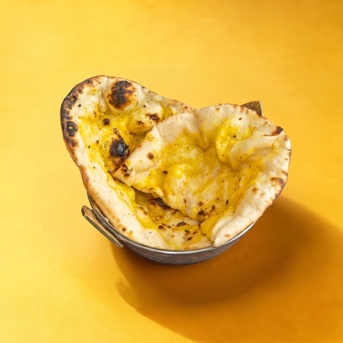 Garlic naan in a steel basket
