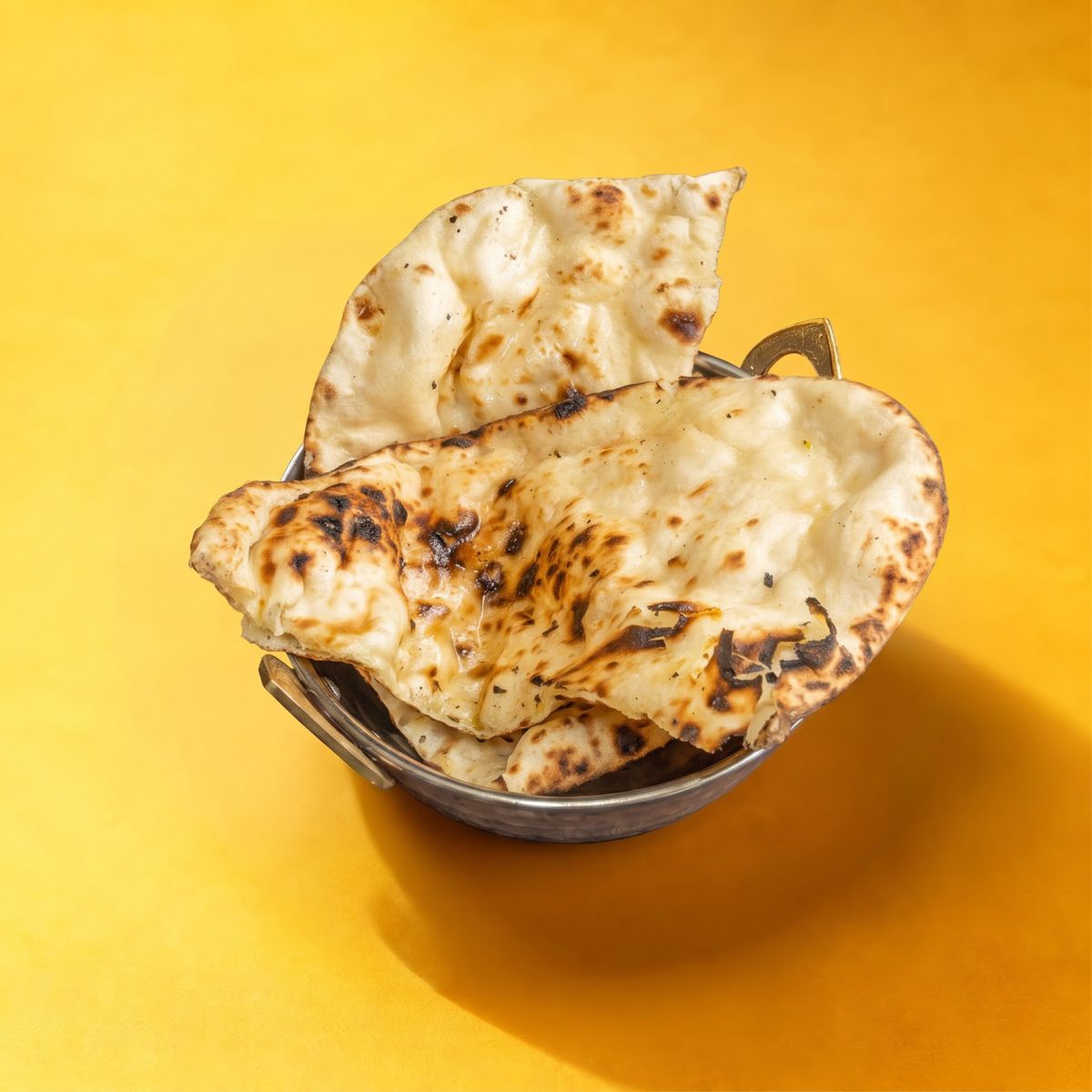 Plain naan in a steel basket