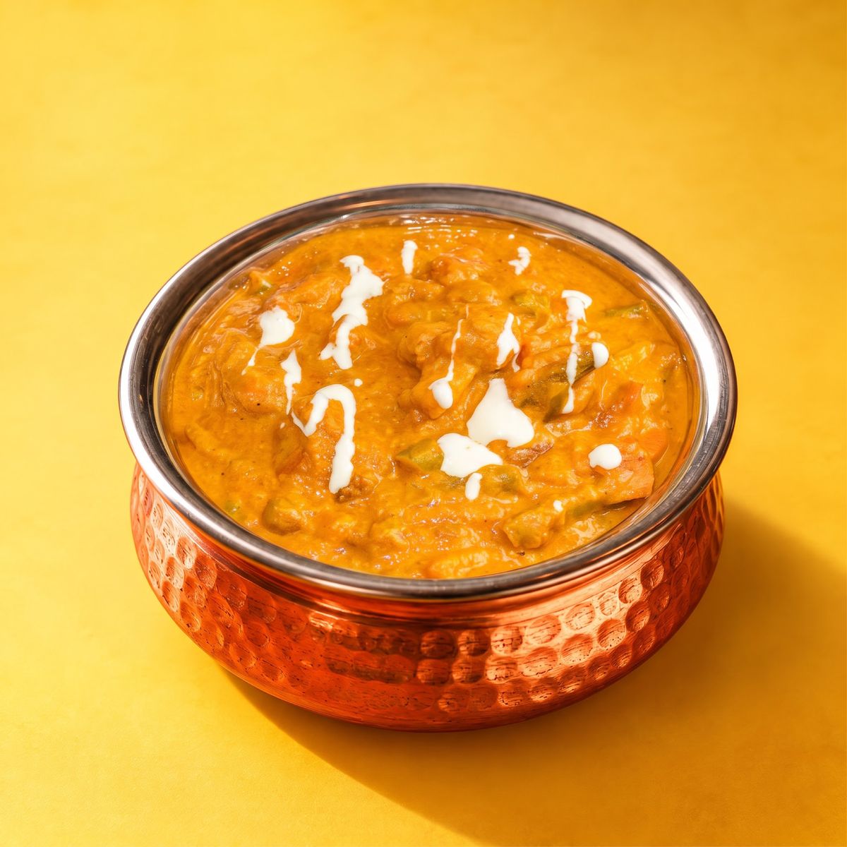 Vegetable korma with a swirl of cream